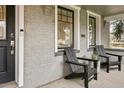 Inviting covered porch featuring stylish chairs and a painted brick facade at 1401 S Clarkson St, Denver, CO 80210