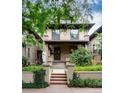 Charming brick two-story home with manicured front yard and inviting front porch at 1308 York St, Denver, CO 80206