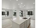 Bright, modern kitchen featuring a large island with quartz countertops and stainless steel appliances at 2036 S Holly St # 4, Denver, CO 80222