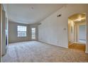 Bright living room with neutral carpet and access to the outside patio at 2875 Blue Sky Cir # 4-303, Erie, CO 80516