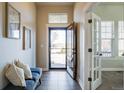 Bright entryway with tile floors, natural light and french doors leading to office at 8992 E 5Th Pl, Denver, CO 80230