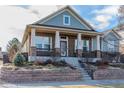 Charming home with a welcoming front porch and beautiful stone and siding accents at 8992 E 5Th Pl, Denver, CO 80230