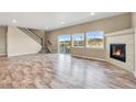 Bright and open living room featuring a fireplace, large windows, and a sliding glass door to the patio at 1677 Valley Oak Ct, Castle Rock, CO 80104