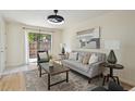 The living room features a sliding glass door, neutral decor, and hardwood floors at 9338 W Utah Pl, Lakewood, CO 80232