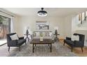 A comfortable living room space with hardwood floors, neutral decor, and natural light at 9338 W Utah Pl, Lakewood, CO 80232