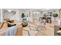 Open-concept living room featuring hardwood floors, natural light, a comfortable sofa, and a staircase at 3798 S Wabash St, Denver, CO 80237