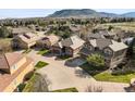 An aerial view of a neighborhood showcasing well-maintained homes, green lawns, and mature trees at 6475 Umber Cir, Arvada, CO 80007