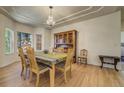 Formal dining room with hardwood floors, chandelier, and large windows offering ample natural light at 2462 W Peakview Ct, Littleton, CO 80120