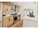 Well-equipped kitchen featuring stainless steel appliances, modern cabinets, and quartz countertops at 1344 N Knox Ct, Denver, CO 80204