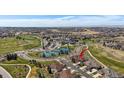 Aerial view showcases this home near a golf course, clubhouse, and tennis courts in a picturesque community at 7895 S Zante Ct, Aurora, CO 80016