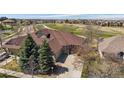 This home features an attached two-car garage, mature landscaping, and is situated near a golf course at 7895 S Zante Ct, Aurora, CO 80016