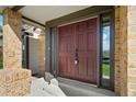 Front entrance featuring a double door, brick columns, and a covered porch at 20838 Parliament Ct, Parker, CO 80138