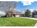Two-story home with large front yard, mature trees, and a three-car garage at 20838 Parliament Ct, Parker, CO 80138