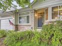 Inviting entrance with a stylish door, brick accents, and well-tended landscaping at 19346 E Clear Creek Way, Parker, CO 80134