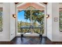 Elegant foyer with large window showcasing mountain views, slate floors and sconces at 290 Skyhill Dr, Evergreen, CO 80439