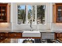Gourmet kitchen with stainless steel appliances, farmhouse sink, and granite countertops at 290 Skyhill Dr, Evergreen, CO 80439