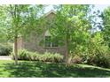 A lush green lawn and trees add to the charm of this home's exterior at 18784 E Linvale Pl, Aurora, CO 80013