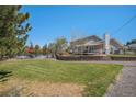 Spacious backyard with a fenced pool area, retaining wall, patio and mature landscaping at 6871 S Himalaya Way, Centennial, CO 80016
