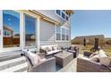 Inviting outdoor patio features stylish wicker furniture, perfect for relaxing and entertaining at 13485 Niagara St, Thornton, CO 80602