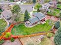 Aerial view of a lovely home featuring a spacious backyard with lush lawn, garden, shed, and mature trees at 1860 E Geddes S Cir, Centennial, CO 80122