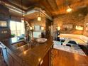 Open concept kitchen with stone accents, a breakfast bar, and an adjoining living space at 10111 Inverness Main St # 223, Englewood, CO 80112
