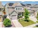 Charming two-story home with a three car garage, solar panels and well-manicured lawn at 14565 Vancouver Pl, Parker, CO 80134