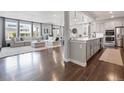 Open-concept living space featuring hardwood floors, modern décor, and bright natural light at 14565 Vancouver Pl, Parker, CO 80134
