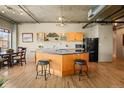 Modern kitchen with wood cabinets, granite countertops and island at 1499 Blake St # 4O, Denver, CO 80202