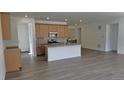 Bright open-concept kitchen features a central island and wooden cabinets at 17156 W 92Nd Loop, Arvada, CO 80007