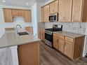 Modern kitchen features wooden cabinets, stainless steel appliances, and gray countertops at 17156 W 92Nd Loop, Arvada, CO 80007