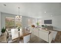 Beautifully staged living room with hardwood flooring and light neutral color palette at 17156 W 92Nd Loop, Arvada, CO 80007