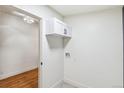 Convenient laundry room includes overhead storage cabinet and modern design at 5523 Tejon St, Denver, CO 80221