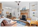 Bright living room with fireplace, built-in shelving, and hardwood floors at 1529 E 22Nd Ave, Denver, CO 80205
