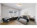 Comfortable bedroom featuring neutral colors and a cozy sitting area at 7932 E 49Th Pl, Denver, CO 80238