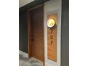 Modern condo front door with a wall light and clear numbering at 1901 Wazee St # 707, Denver, CO 80202