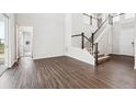 Bright and airy living room with hardwood floors, staircase, and white walls at 2464 Wesley Ln, Lafayette, CO 80026