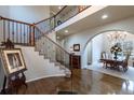 Elegant entryway with hardwood floors and a curved staircase at 2675 Timberchase Trl, Highlands Ranch, CO 80126