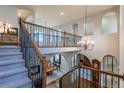 Open staircase leading to upper level with wrought iron railings at 2675 Timberchase Trl, Highlands Ranch, CO 80126