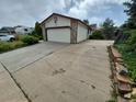Spacious driveway leading to an attached garage, offering ample parking for multiple vehicles at 2758 S Salida St, Aurora, CO 80013