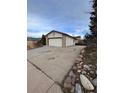 Charming home featuring a two-car garage with a long driveway and stone accents at 2758 S Salida St, Aurora, CO 80013