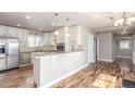 Modern kitchen with stainless steel appliances, white cabinetry, and granite countertops at 1350 Valentia St, Denver, CO 80220