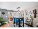 Dining room with modern lighting, bar, and access to outdoor space for relaxation and entertainment at 1271 Braewood Ave, Highlands Ranch, CO 80129