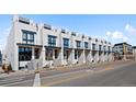 Row of modern townhomes showcasing stylish facade, street view, and consistent architectural design at 4263 E 8Th Ave, Denver, CO 80220