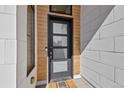 Close-up of a modern front door with sleek design and mixed materials at 4263 E 8Th Ave, Denver, CO 80220