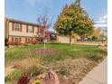 Inviting two-story home featuring a manicured lawn and a lovely tree-lined street in a peaceful neighborhood at 9510 Flower St, Broomfield, CO 80021