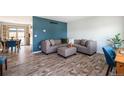 Stylish living room with a comfortable gray sectional sofa, wood-look flooring, and bright, modern decor at 9510 Flower St, Broomfield, CO 80021