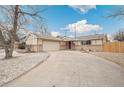 Inviting ranch home with attached garage and extended driveway on a sunny day at 3596 E Fair Pl, Centennial, CO 80121