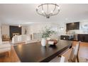 Bright dining room featuring a dark wood table and chandelier at 4751 S Xenia St, Denver, CO 80237