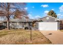 Charming single-story home boasts a freshly painted gray exterior, attached garage, and well-maintained front yard at 4751 S Xenia St, Denver, CO 80237