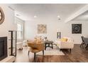 Open living room with hardwood floors, fireplace, and bright natural light at 13020 E Linvale Pl, Aurora, CO 80014